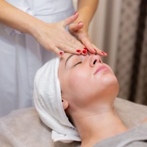 young-beautiful-girl-lies-beautician-s-table-receives-procedures-light-facial-massage-using-oil-1-1-scaled.jpg